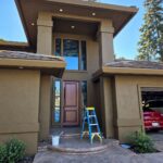 Freshly painted two-story Sacramento home entryway with ladder and painting supplies