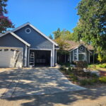 Completed dark gray exterior paint with white trim on a Sacramento home