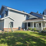 Freshly painted light blue house exterior with white trim