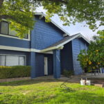 Fresh exterior paint in navy blue with white trim on a Sacramento home